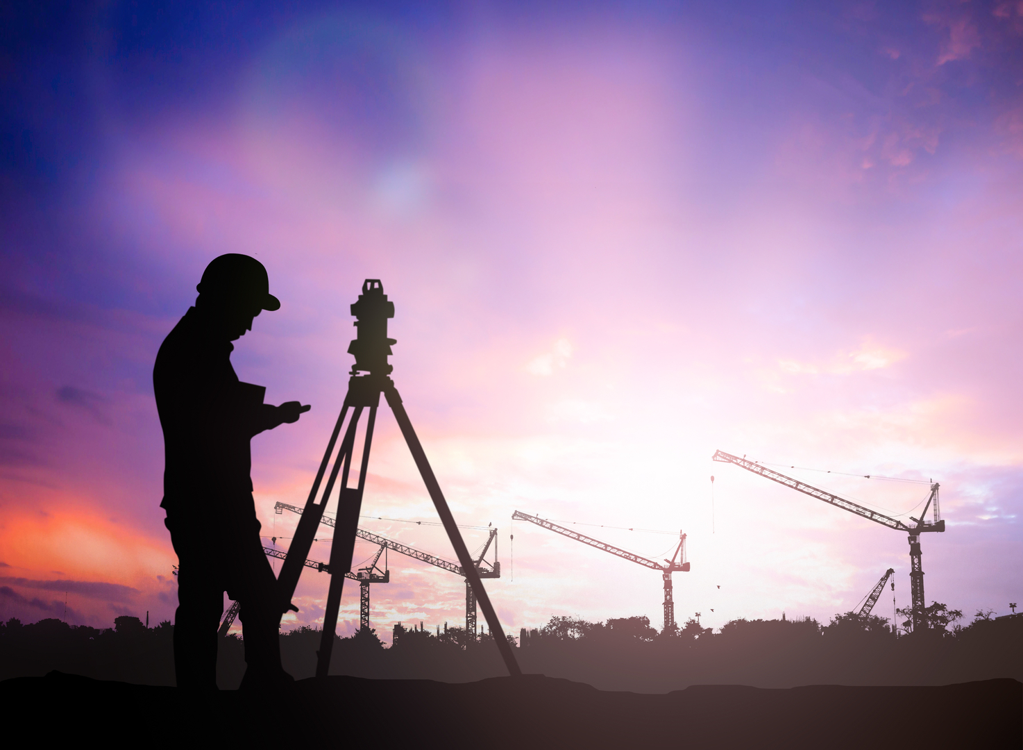 silhouette survey engineer working in a building site over Blur